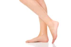 Woman's legs beneath the knees show smooth texture without visible veins.