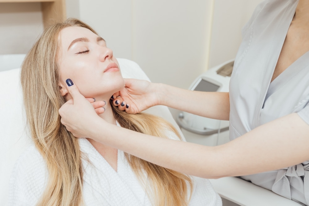 Woman having her face examined to see if she's a candidate for JEUVEAU in Ann Arbor